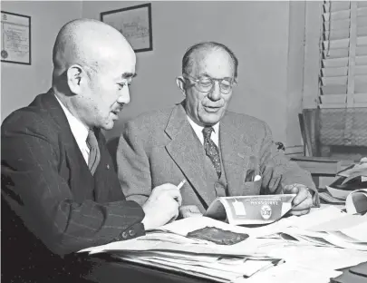  ?? THE COMMERCIAL APPEAL FILES ?? The needs of Japan for cotton were discussed in February 1951 by S. Komamura, left, president of the All Japan Cotton Traders Associatio­n, with A.E. Hohenberg, of Hohenberg Bros. Co. Mr. Komamura, who headed a delegation of Japanese cotton men to Memphis, is the president of the Gosho Company, Ltd., which is an agent for the Hohenberg firm in Japan.