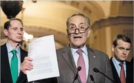  ?? NICHOLAS KAMM/GETTY-AFP ?? Senate Minority Leader Chuck Schumer, D-N.Y., shows a letter written to GOP leaders.