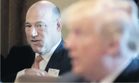  ?? MICHAEL REYNOLDS/POOL ?? Gary Cohn, outgoing director of the U.S. National Economic Council, listens as U.S. President Donald Trump, right, speaks during a cabinet meeting at the White House on Thursday. Trump opened the session promoting a meeting on steel and aluminum tariffs.