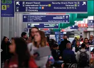  ?? AP ?? Passengers traverse Terminal 3 at O’Hare airport in Chicago in this November photo.