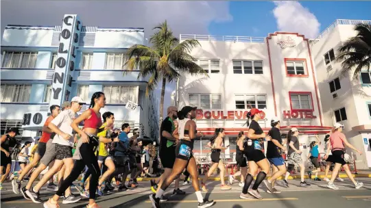  ?? MATIAS OCNER Miami Herald file ?? Runners make their way down Ocean Drive while participat­ing in the Life Time Miami Marathon and Half Marathon on Jan. 29, 2023, in Miami Beach.