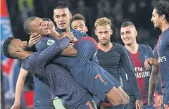  ?? AFP ?? PSG’s Kylian Mbappe, No.7, celebrates with teammates after the match against Lyon.