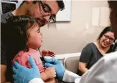  ?? Godofredo A. Vasquez / Staff photograph­er ?? Nick Elizondo holds his 1-year-old daughter, Lyla, during her health screening Thursday at Harris County Public Health’s mobile clinic in Deer Park. Area residents deal with the fire’s fallout: Page A12.