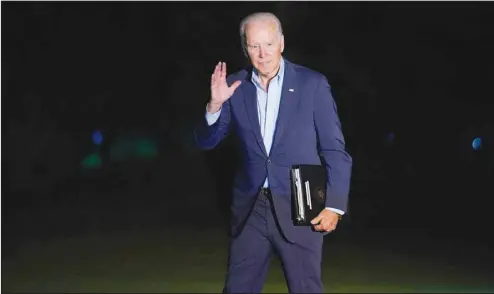  ?? (AP) ?? President Joe Biden waves as he walks from Marine One across the South Lawn of the White House in Washington, late Sunday, July 11, 2021, after returning from a weekend in Delaware.