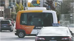  ?? Adrian Wyld / THE CANADI AN PRESS ?? An autonomous shuttle rides past a taxi during a demonstrat­ion in Ottawa on Nov. 2. Statistics Canada says domestic firms that invested in robots since the late
1990s have actually expanded their workforce.