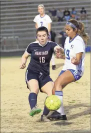  ?? / Scott Herpst ?? Heritage’s Haleigh Nichols fights for possession with a Cass player during last week’s home opener. The Lady Generals won the match, 2-1.