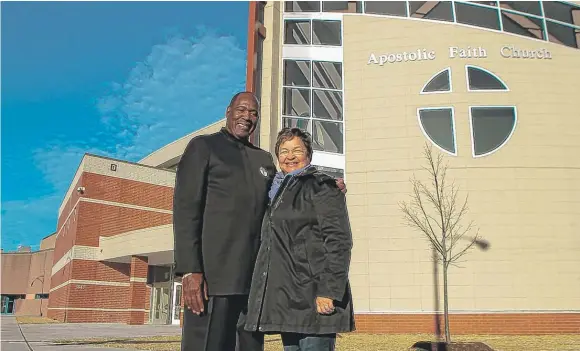  ?? | LESLIE ADKINS/ FOR THE SUN- TIMES ?? Pastor Horace Smith with his wife, Susan Smith, in front of the new Apostolic Faith Church to open Sunday.