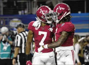  ?? PHOTOS BY JEFFREY MCWHORTER/AP ?? Alabama’s Ja’corey Brooks (left) celebrates scoring a touchdown in Friday’s Cotton Bowl with Jameson Williams, who briefly left the game early in the second half after getting hit hard on a kickoff return.