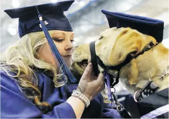  ?? GAVIN YOUNG/ CALGARY HERALD ?? Mount Royal University disability studies graduate Alyssa Denis shares a moment with her service dog Moxie before graduating and delivering the valedictor­ian speech Thursday.
