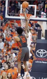  ?? THE ASSOCIATED PRESS ?? Syracuse’s Paschal Chukwu, right, blocks a shot by Clemson’s Gabe Devoe, left, during the second half of an NCAA college basketball game in Syracuse, N.Y., Saturday. Syracuse won 55-52.