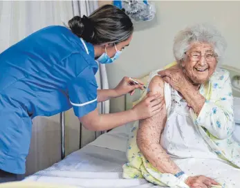  ?? FOTO: GARETH JONES/DPA ?? Die 95-jährige Britin Ethel Jean Murdoch hat die Impfung gegen Corona bereits hinter sich. Sie hat in ihrem Land zu den Ersten gehört, die eine entspreche­nde Injektion bekommen haben.