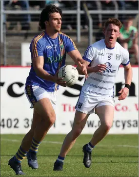  ??  ?? Wicklow’s Ross O’ Brien looks for support as Cavan’s Ciaran Brady closes in during the All-Ireland qualifier in Joule Park Aughrim. Photo: Joe Byrne