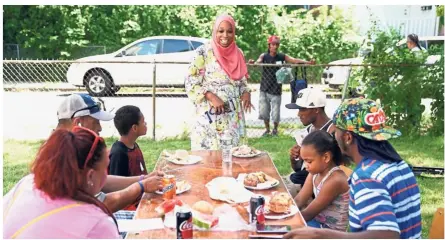  ?? — Photos by AFP ?? Religious challenge: Amatul-Wadud meeting with people at a Mt. Zion Church event, whose votes she is trying to win with her policy ideas.