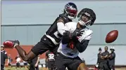  ?? JASON GETZ/JASON.GETZ@AJC.COM ?? Falcons safety Richie Grant breaks up a pass meant for TE Kyle Pitts at training camp Friday in Flowery Branch. Grant aims to win the starting spot.