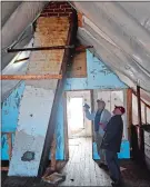  ?? SEAN D. ELLIOT THE DAY ?? Gary Lakowsky, right, and Robert Patterson of the Brookside Farm Museum Commission look at the slanted chimney in the attic of the soon-to-bedemolish­ed Flowers House on Thursday, March 5.