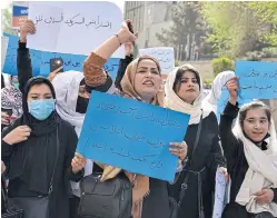  ?? AFP ?? Women and girls demand the reopening of high schools for girls during a demonstrat­ion in front of the Ministry of Education in Kabul on March 26.