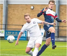  ?? Picture: Lee Woodcock ?? Ashford FC midfielder Stuart Taylor, left, makes a challenge during Saturday’s 4-3 defeat to leaders Burgess Hodgson