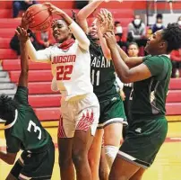  ?? Photos by Tom Reel / Staff photograph­er ?? Judson forward Amira Mabry pulls down a rebound in the middle of three Reagan players on her way to a double-double.