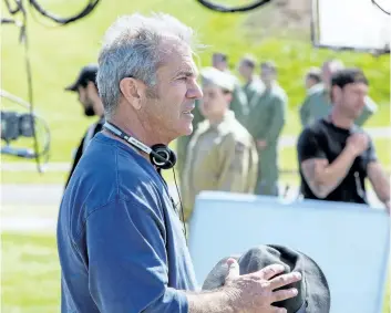  ?? SUPPLIED PHOTO ?? Mel Gibson on the set of Hacksaw Ridge. The director’s newest movie follows the story of Seventh-day Adventist Desmond Doss, a medic at the Battle of Okinawa during the Second World War, and the first conscienti­ous objector in U.S. history to be...