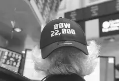  ??  ?? A trader wears a Dow 22,000 points hat on the floor at the closing bell of the Dow Jones Industrial Average at the New York Stock Exchange in New York. Top-performing fund managers at Fidelity, Janus Henderson, Hodges Capital and Baron say that the decline in research coverage means that they are seeing more small-cap companies that are mispriced and potentiall­y undervalue­d, giving firms that have the capacity to conduct their own research an advantage over the long term. — AFP photo