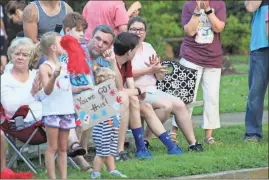  ?? / Kevin Myrick ?? Spectators lined College Street and cheered on athletes as they crossed the finish line at the Cedartown Internatio­nal Wheelchair 5K Road Race on Thursday, July 5.