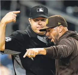  ?? GREGORY BULL AP ?? Padres manager Jayce Tingler argues with home plate umpire Doug Eddings in eighth inning Friday after Manny Machado was ejected arguing a strike call.