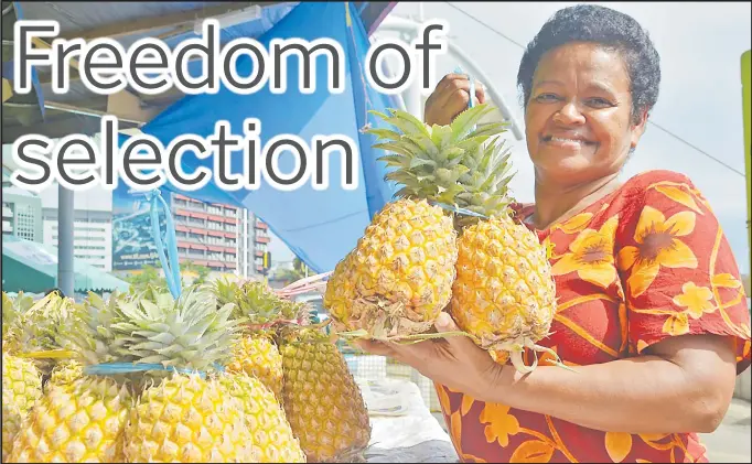  ?? Picture: ATASA MOCEITUBA ?? Rosi Batimala shops for pineapples at the Suva market.
