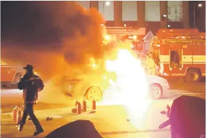  ??  ?? Photo shows a burning taxi vehicle on the road near the US embassy in central Seoul.