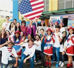  ??  ?? (Fifth and sixth right, third row) Lakhdhir, Lee and Prof Wilkinson (standing, last row) pose with students at the celebratio­n of American Education Day.