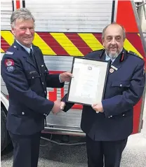  ??  ?? Camaraderi­e . . . Oamaru Volunteer Fire Brigade’s longservin­g senior firefighte­r Mike Isbister (left) and chief fire officer Steve Couper.