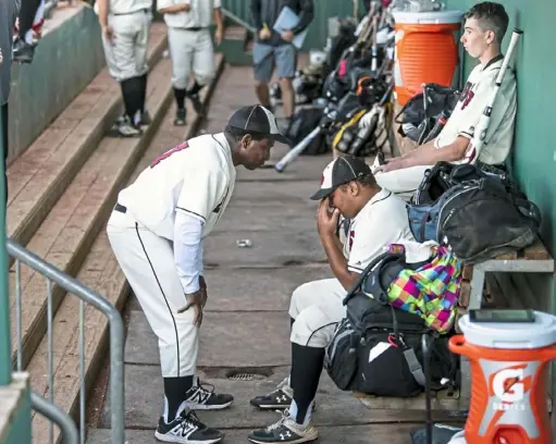  ?? Alexandra Wimley/Post-Gazette ?? Serra Catholic coach Dennis Stitch comforts his son, Emmanuel, after he fouled out at the plate in the PIAA Class 2A championsh­ip game Friday in University Park. The Eagles’ season ended with a loss to Devon Prep, 3-2.