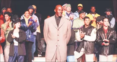  ?? Associated Press file photo ?? In this March 2, 1999, photo, Michael Jordan stands with a group of models at the Bellagio Hotel in Las Vegas where he previewed the Fall/Holiday 1999 Jordan collection, a sub-brand of Nike. By the 1980s, America finally publicly embraced the black...