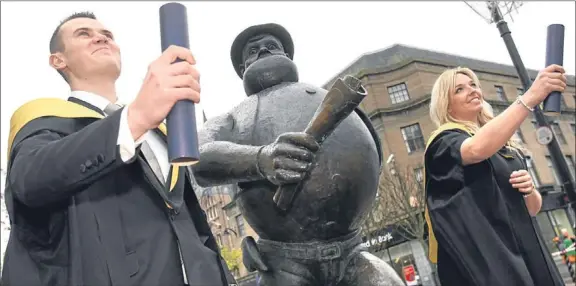  ??  ?? School of business graduates Slawek Gargas and Jamie Bronoski take a leaf out of Desperate Dan’s book as they celebrate their degrees.