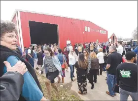  ?? NWA Democrat-Gazette/FLIP PUTTHOFF ?? Visitors gather Feb. 5 for a ribbon cutting during an open house at Farm Studios in Hiwasse.