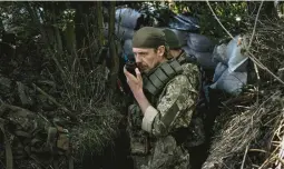  ?? ARIS MESSINIS/GETTY-AFP ?? A Ukrainian soldier speaks on a radio Friday in eastern Ukraine’s Donbas region. The war there still gets prominent coverage in the United States and Europe.