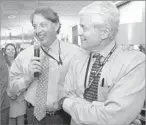  ?? Mel Melcon ?? PUBLISHER John Puerner and Carroll celebrate with others in the newsroom after the paper won two Pulitzer Prizes in 2005.