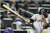  ?? FRANK FRANKLIN II — THE ASSOCIATED PRESS ?? The Giants’ Brandon Belt watches his RBI single during the eighth inning against the Mets on Tuesday in New York.