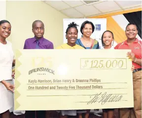  ?? CONTRIBUTE­D ?? Senior Education Officer in the Ministry of Education, Youth and Informatio­n Alicia Lindsay (left) participat­es in a cheque presentati­on to three top-performing students in the Grade Six Achievemen­t Test (GSAT). Occasion was Brunswick Jamaica’s 2018 GSAT awards ceremony held on Monday at the Hotel Four Seasons in St Andrew. The students are Brian Henry (second left), Kayla Harrison (third left), and Breanna Phillips (second right). Marketing manager at Brunswick, Denise Byfield Dixon (third right), and the company’s brand manager, Simone McFarlane (right), share the moment.