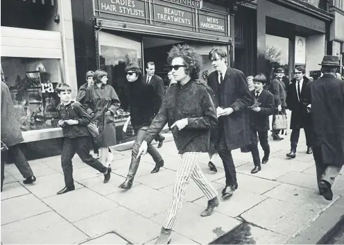  ??  ?? Dylan makes his way along Princes Street in Edinburgh. His Glasgow show the night before was marred by ugly crowd scenes