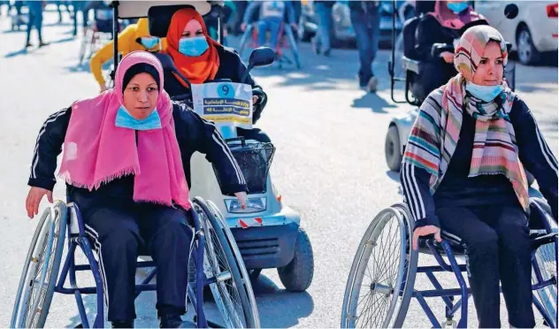  ?? Agence France-presse ?? ↑
Palestinia­ns take part in a wheelchair race during an event marking the Internatio­nal Day of Persons with Disabiliti­es in Gaza City on Thursday.