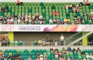  ?? CHARLIE RIEDEL/AP ?? Fans watch during the World Championsh­ips on Friday in Eugene, Oregon. The running mecca that embedded Nike into American culture was an easy choice to host the first track world championsh­ips on U.S. soil, but it is a niche sport for spectators in the U.S.