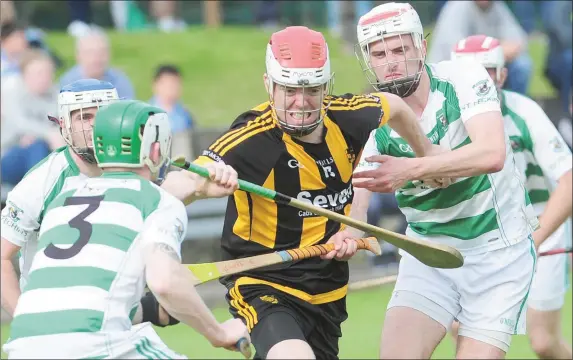  ??  ?? David Yore, Naomh Moninne attempts to break away from St. Fechins players during the Senior Hurling Championsh­ip Final in The Grove, Castlebell­ingham.