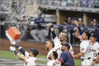  ?? GREGORY BULL/ AP ?? Astros players celebrate after shortstop Carlos Correa hit awalk- offhome run in the ninth inning to defeat the Rays 4- 3 inGame 5 of theALCS. Houston will try to even the series today.