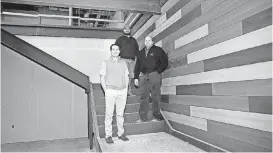  ?? [PHOTO BY SARAH PHIPPS, THE OKLAHOMAN] ?? Broker Jonathan Thompson, left, Harrison Turner, commercial project manager, and Derek Turner, president of Turner &amp; Co., stand in a stairway of a building being remodeled at 200 N Bryant Ave., in Edmond.