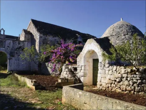  ?? CAIN BURDEAU VIA AP ?? An abandoned trullo and farm await in the Valle d’Itria, a quiet place in Puglia, Italy, of rolling green hills, meandering country roads, endless stone walls, singular cone-roofed country cottages, rock-solid peasants and earthy food and wine.