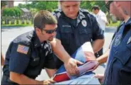  ??  ?? First responders fold the flag.