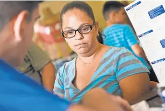  ?? JASPER COLT/ USA TODAY ?? Eva Medina has her blood pressure checked at a community center in the Mameyes neighborho­od of Jayuya, where a temporary clinic provides basic medical services.