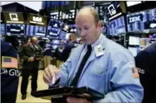  ?? RICHARD DREW — THE ASSOCIATED PRESS ?? Trader Peter Mancuso works on the floor of the New York Stock Exchange, Thursday.