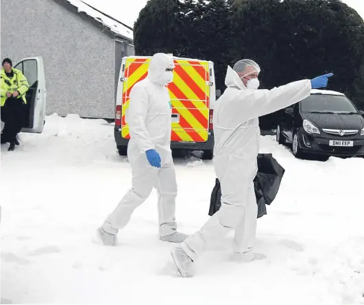  ?? Picture: Gareth Jennings. ?? Police forensics officers march through the snow to gather evidence at the scene in Alyth yesterday.