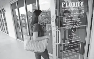  ?? WILFREDO LEE/ASSOCIATED PRESS ?? A woman enters a Florida Highway Safety and Motor Vehicles driver license service centerTues­day in Hialeah, Fla. The U.S. Census Bureau has asked the 50 states for drivers’ license informatio­n, months after President Donald Trump ordered the collection of citizenshi­p informatio­n.